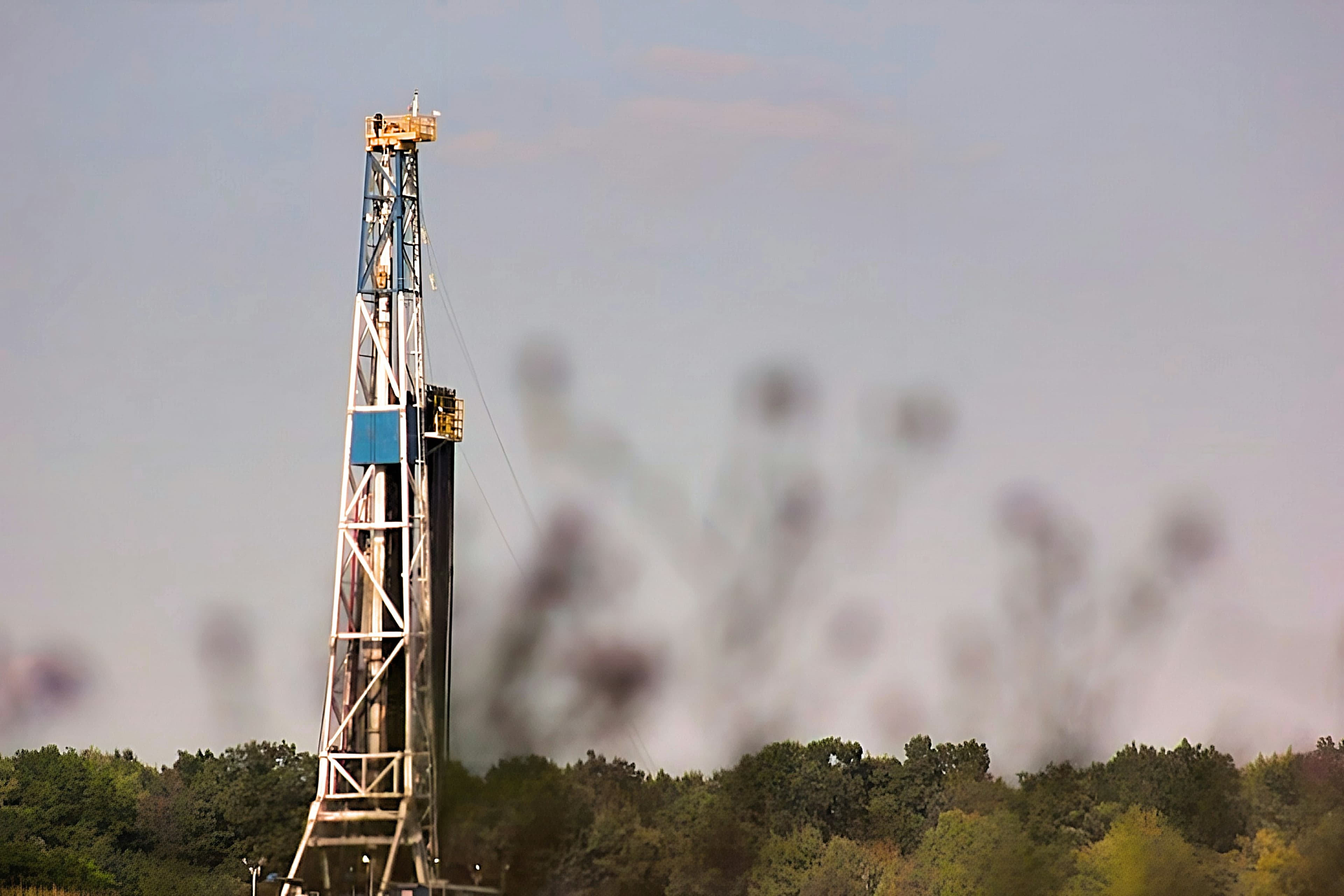 Drilling rig on a pad cut out of timber country