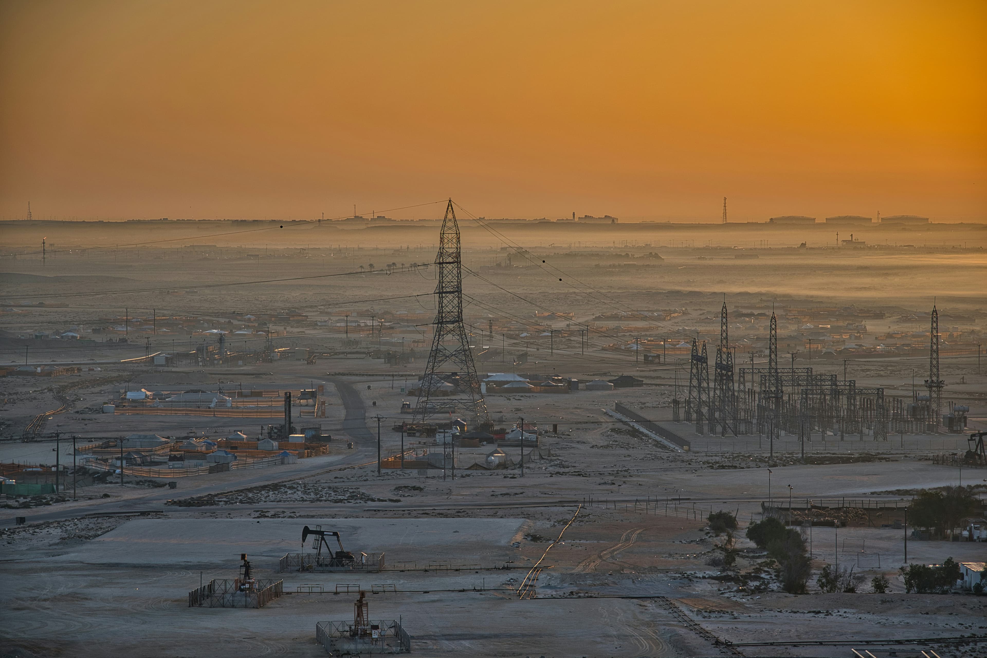 Producing field with pump jacks in morning haze